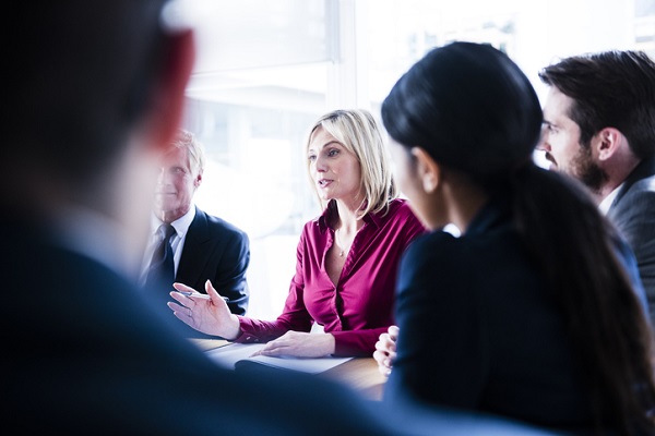 A Professional Woman Talking To Colleagues.