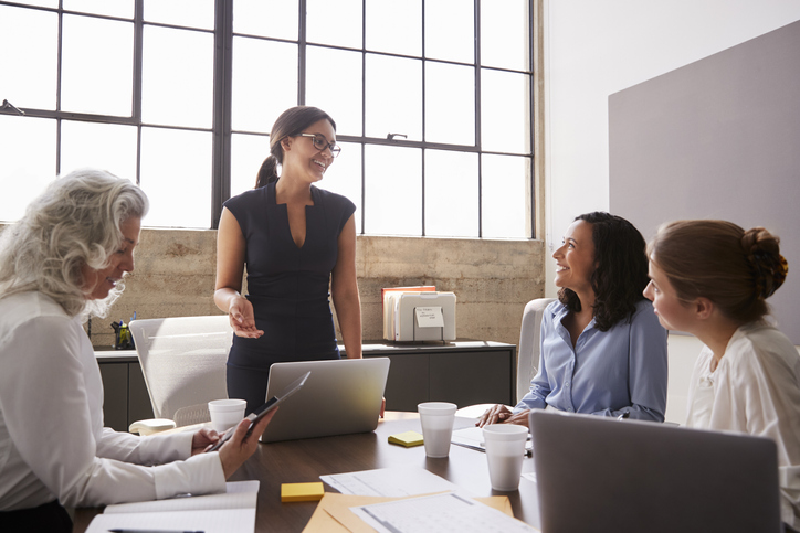 Woman Addressing Female Colleagues In A Meeting.