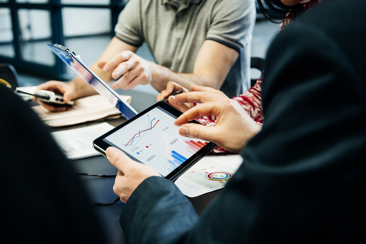 A Group Of People Holding A Meeting.